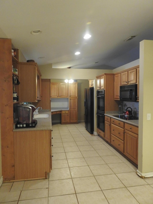 kitchen with decorative backsplash, light tile patterned floors, sink, and black appliances