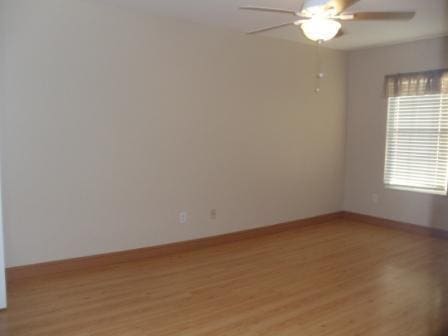 spare room featuring ceiling fan and light wood-type flooring