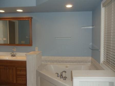 bathroom with vanity and a bathtub