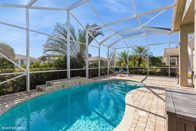 view of pool featuring a patio area and glass enclosure