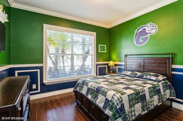 bedroom with dark wood-style floors, crown molding, and baseboards