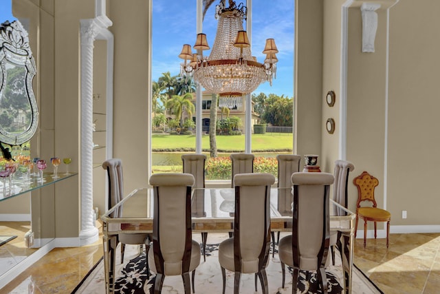 dining area with an inviting chandelier and baseboards