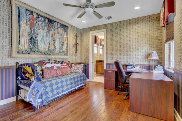 bedroom with connected bathroom, wood-type flooring, recessed lighting, wallpapered walls, and visible vents