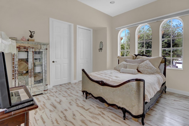 bedroom featuring baseboards and wood finished floors