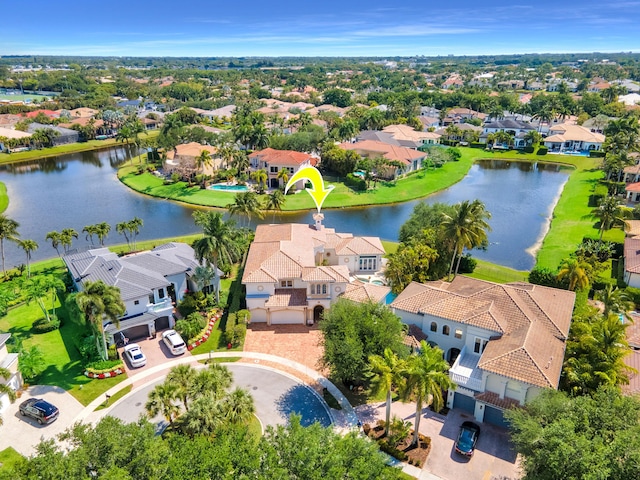 drone / aerial view with a water view and a residential view