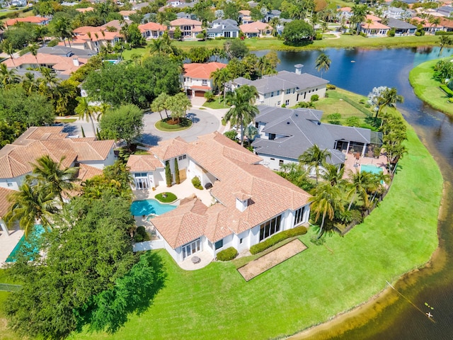 drone / aerial view with a water view and a residential view