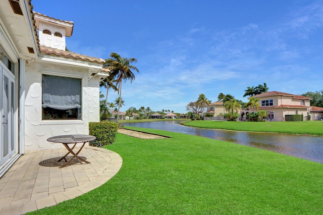 view of yard featuring a water view and a residential view