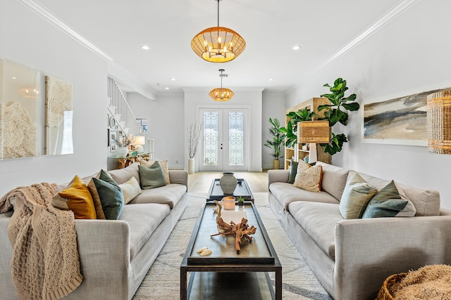 living room featuring a chandelier, french doors, and crown molding