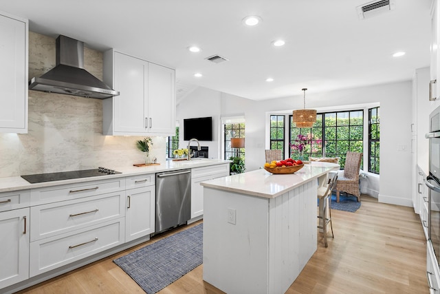 kitchen with white cabinetry, dishwasher, wall chimney range hood, tasteful backsplash, and pendant lighting