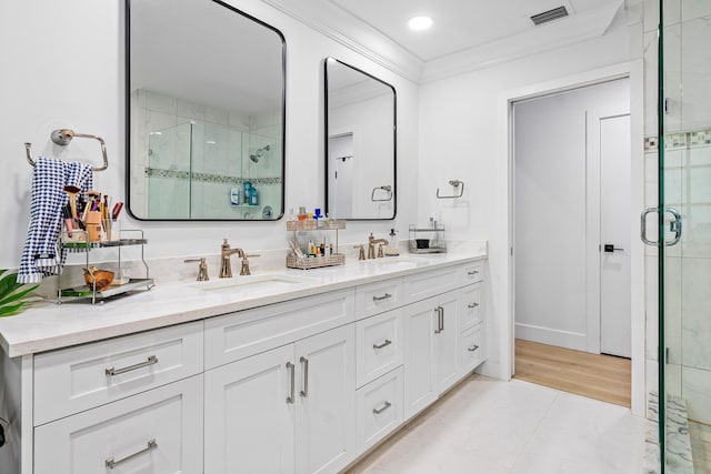 bathroom featuring tile patterned floors, crown molding, vanity, and an enclosed shower