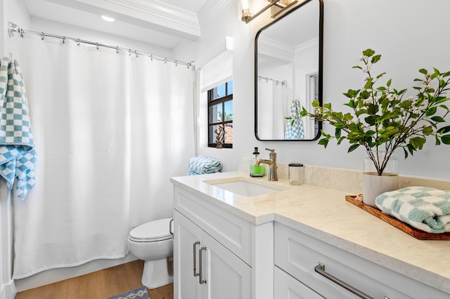 bathroom featuring hardwood / wood-style floors, vanity, toilet, and crown molding