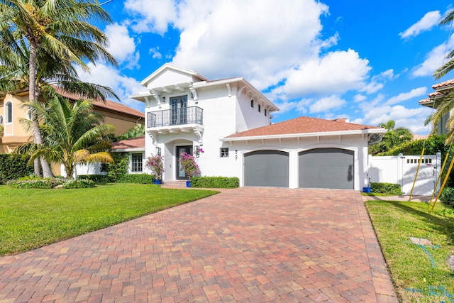 mediterranean / spanish house with a balcony and a front yard