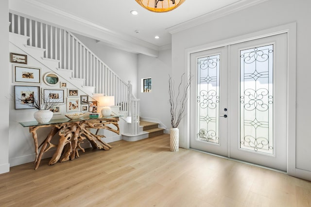 entrance foyer featuring ornamental molding, a wealth of natural light, and french doors