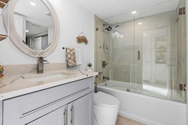 full bathroom featuring vanity, toilet, and enclosed tub / shower combo