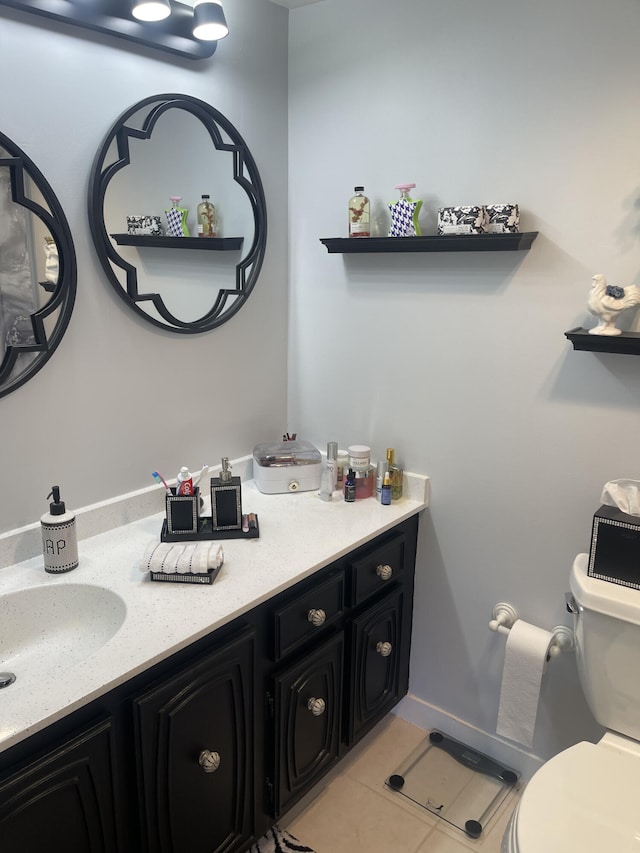 bathroom with tile patterned floors, vanity, and toilet