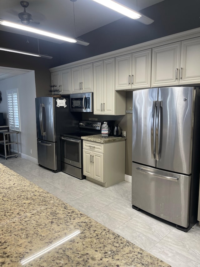 kitchen with light tile patterned flooring and stainless steel appliances