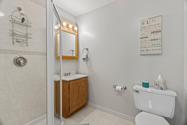 bathroom featuring tile patterned floors, vanity, toilet, and tiled shower