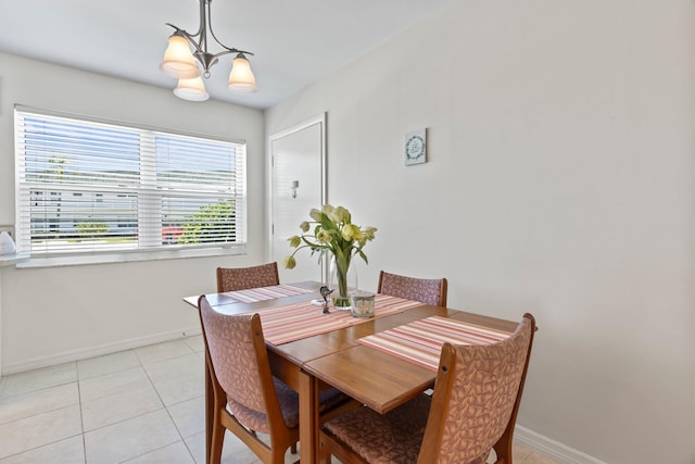 dining space featuring light tile patterned floors and a chandelier