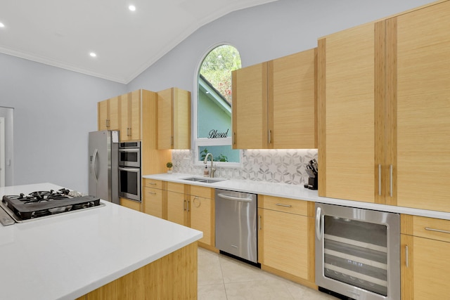 kitchen featuring light brown cabinetry, sink, beverage cooler, and appliances with stainless steel finishes