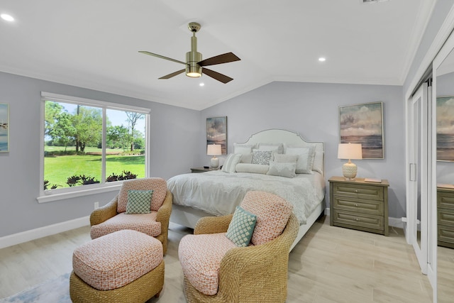 bedroom with light hardwood / wood-style floors, ceiling fan, and lofted ceiling