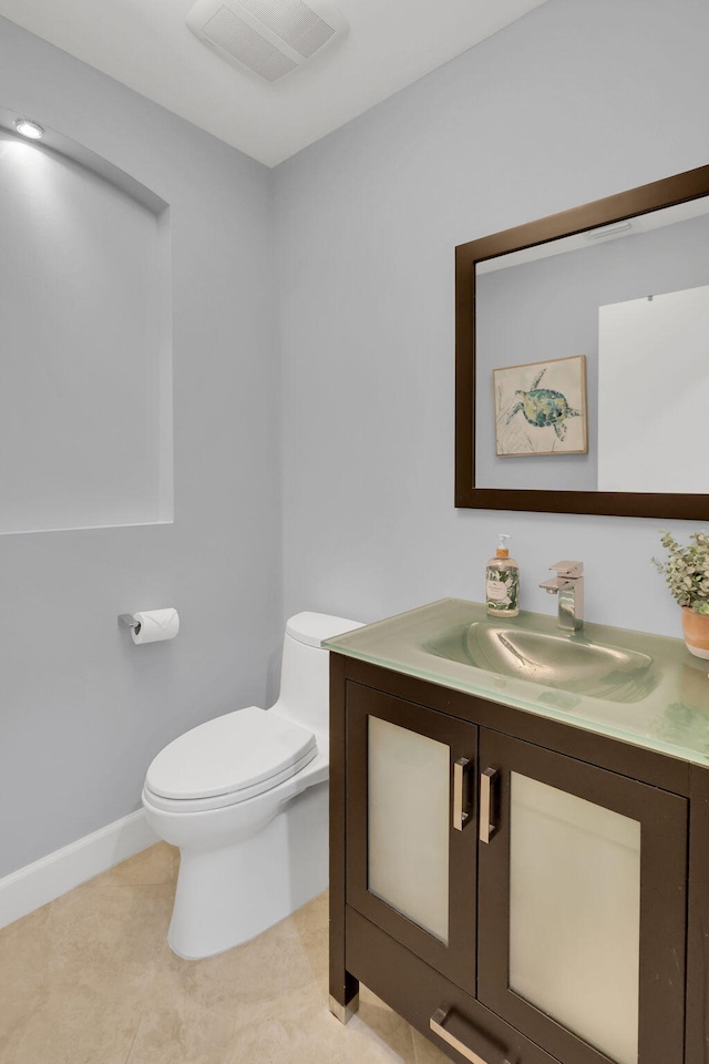 bathroom featuring tile patterned floors, vanity, and toilet