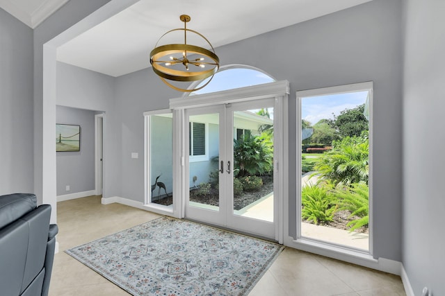 doorway with light tile patterned flooring, french doors, a notable chandelier, and a healthy amount of sunlight