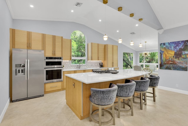 kitchen featuring sink, a center island, decorative light fixtures, decorative backsplash, and appliances with stainless steel finishes