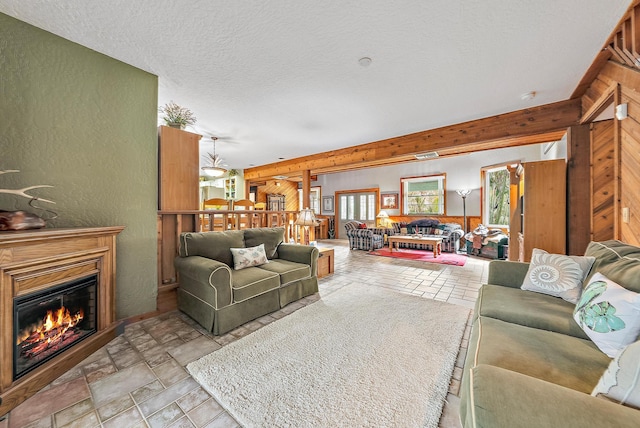 living room with wooden walls and a textured ceiling