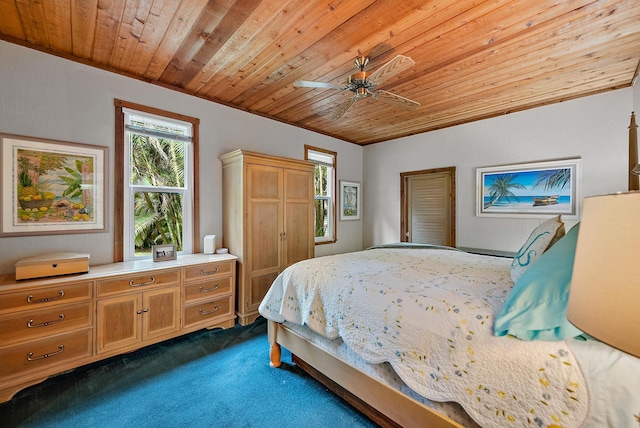 carpeted bedroom featuring ceiling fan, wood ceiling, and ornamental molding