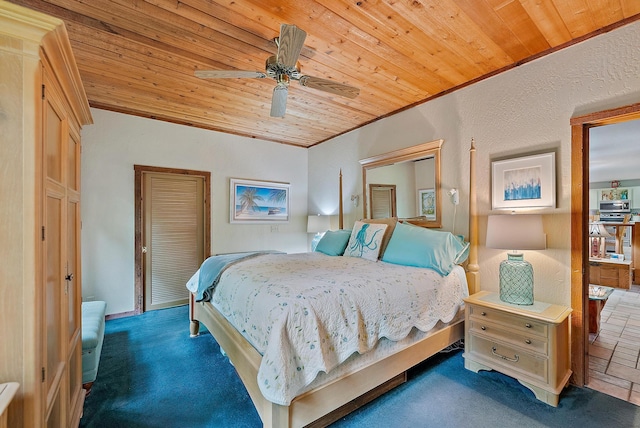 carpeted bedroom featuring ornamental molding, ceiling fan, and wooden ceiling