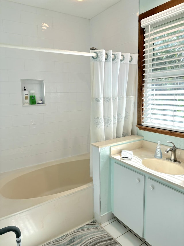 bathroom featuring tile patterned floors, shower / washtub combination, and vanity