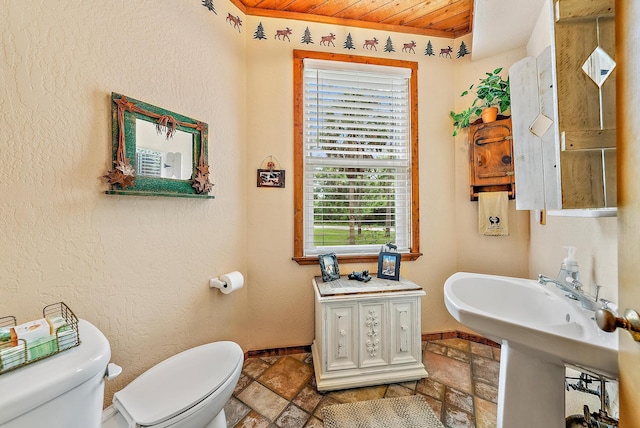 bathroom with wood ceiling and toilet