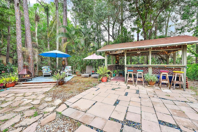 view of patio / terrace with exterior bar and a gazebo