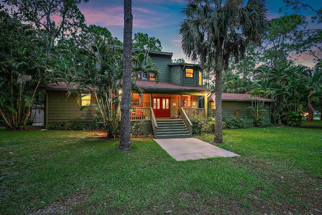 view of front facade featuring a lawn and covered porch