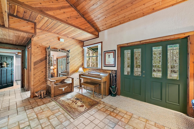 entryway with lofted ceiling, wooden walls, and wood ceiling