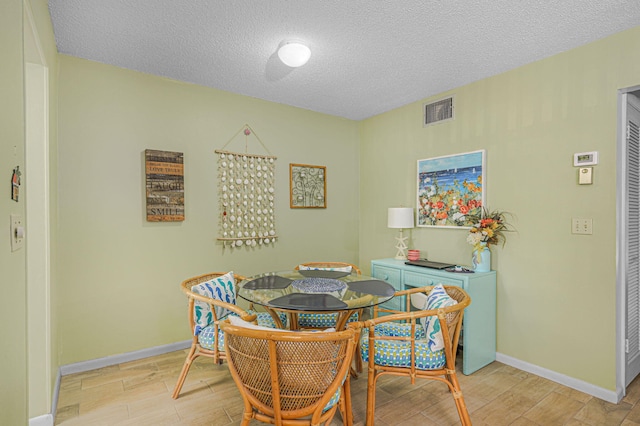 dining room featuring a textured ceiling