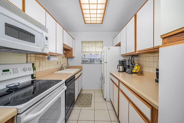 kitchen with white cabinetry, sink, tasteful backsplash, white appliances, and light tile patterned floors