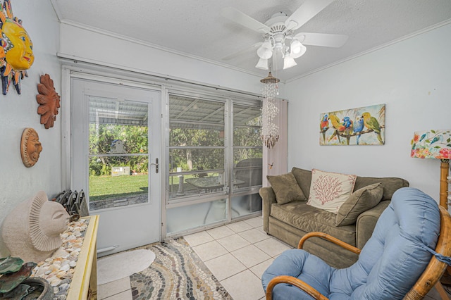 tiled living room featuring ceiling fan, crown molding, and a textured ceiling