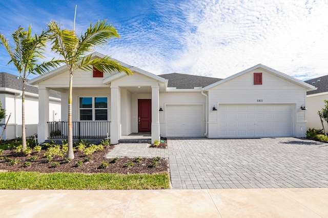 view of front of home featuring a porch and a garage