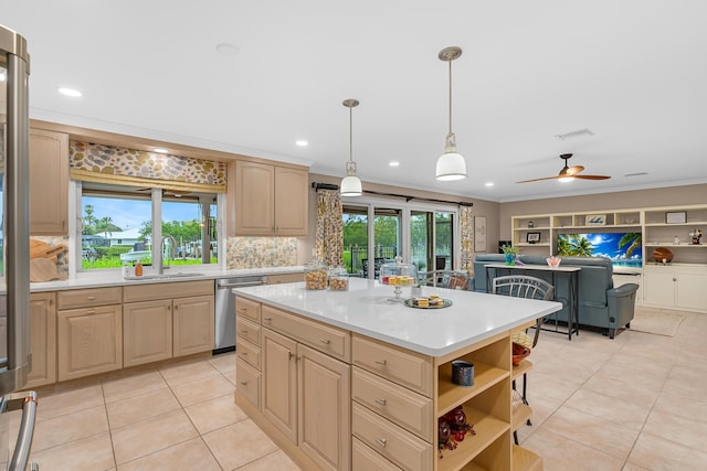 kitchen featuring crown molding, stainless steel dishwasher, sink, a kitchen island, and light brown cabinets