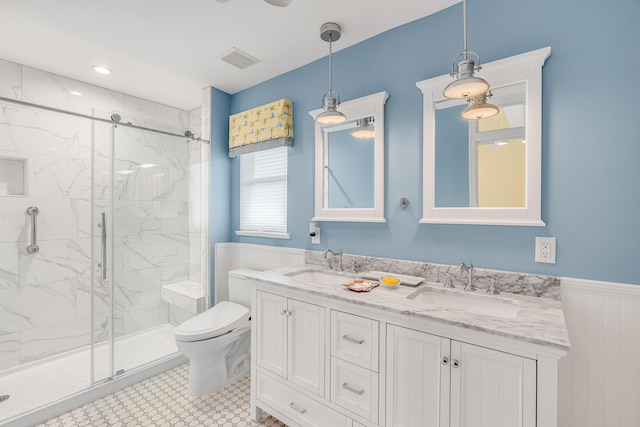 bathroom with a shower with door, toilet, tile patterned floors, and vanity