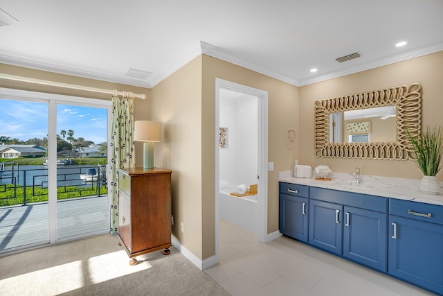 bathroom featuring tile patterned flooring, a bathing tub, vanity, a water view, and crown molding