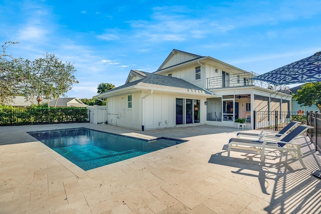 view of swimming pool featuring ceiling fan and a patio