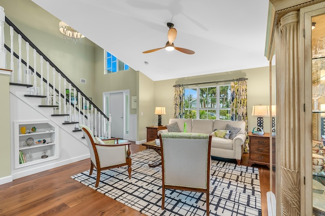 living room with hardwood / wood-style flooring, high vaulted ceiling, and ceiling fan