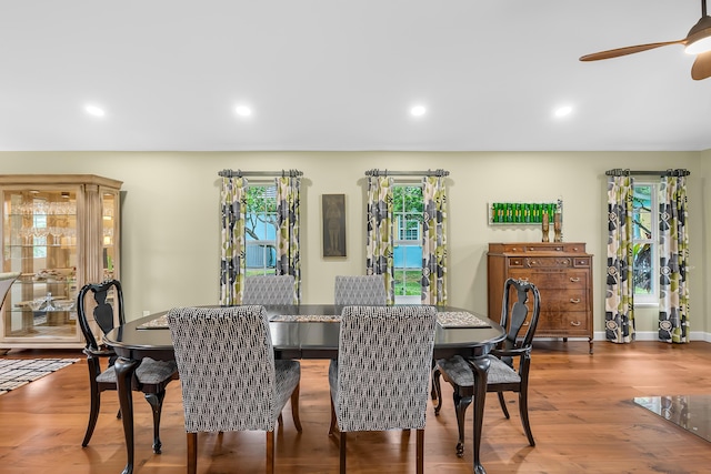 dining area with hardwood / wood-style floors and ceiling fan