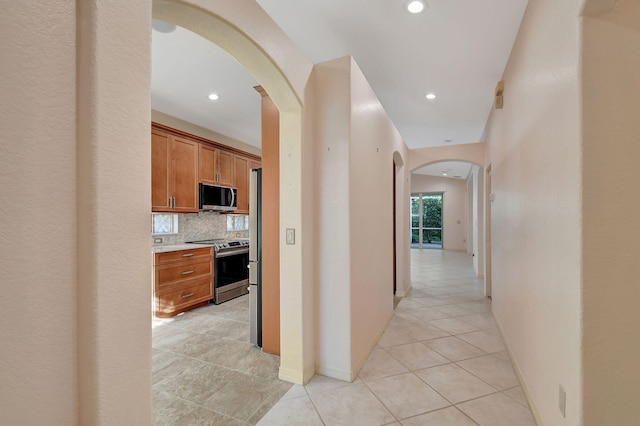 hall with light tile patterned floors