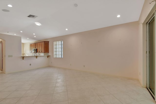 unfurnished living room with light tile patterned floors