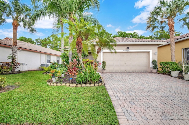 view of front of property with a front yard and a garage