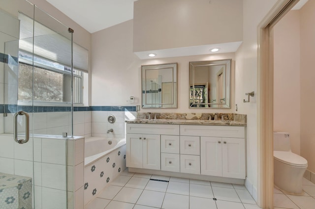 full bathroom with tile patterned floors, vanity, separate shower and tub, and toilet