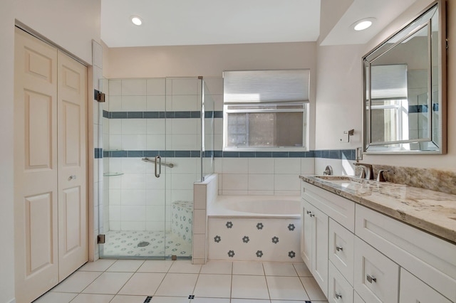 bathroom with tile patterned flooring, vanity, and separate shower and tub